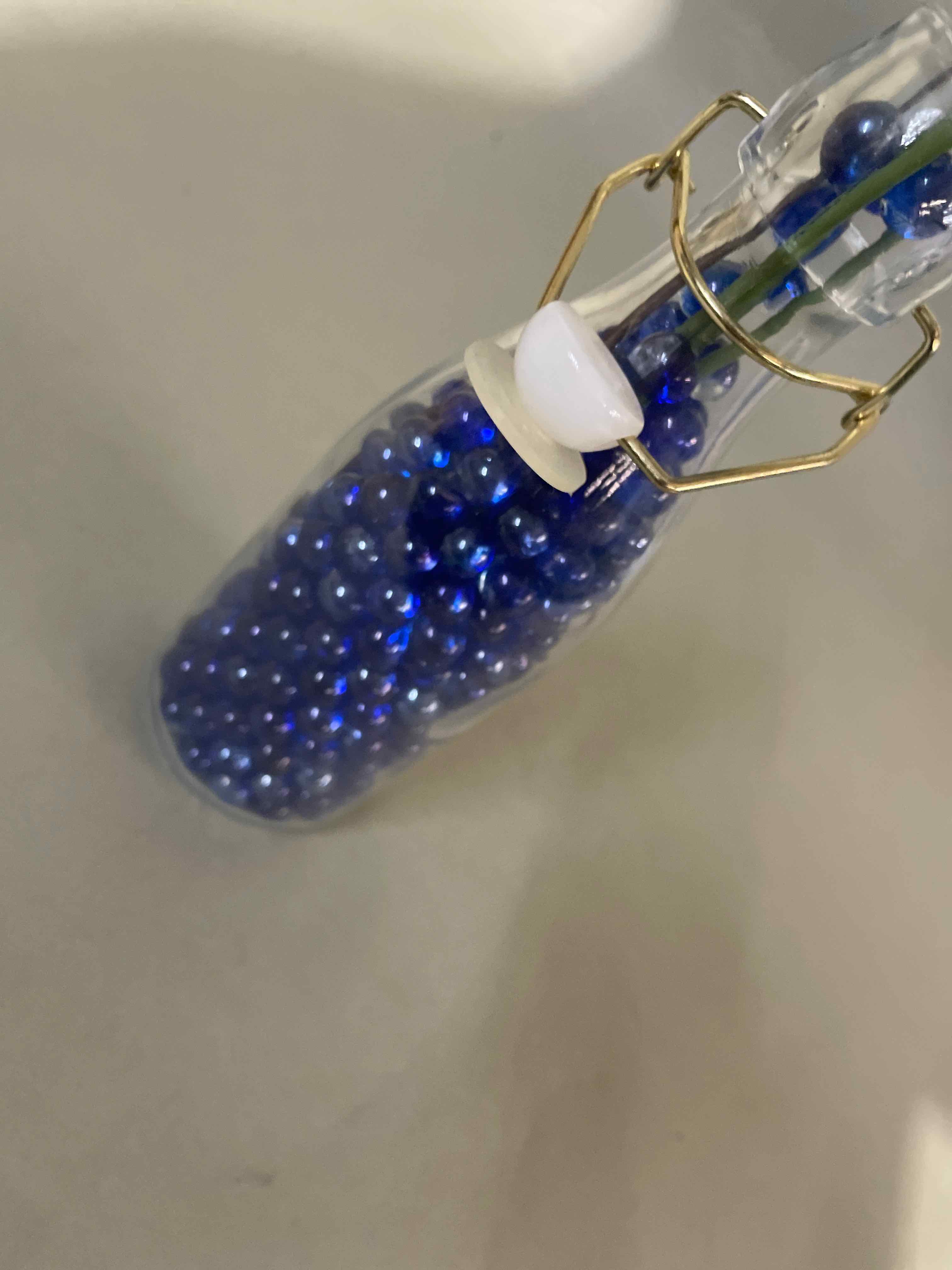 Floral Arrangement Blue Artificial Flowers in Glass Bottle